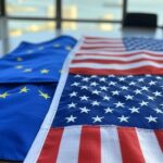 Bandeiras da França, UE e EUA em mesa no Rio de Janeiro, representando rebate irônico a críticas com tabela comparativa.