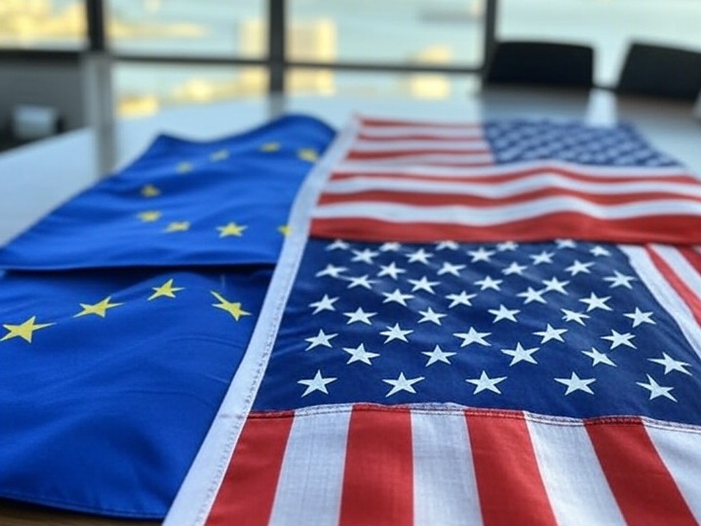 Bandeiras da França, UE e EUA em mesa no Rio de Janeiro, representando rebate irônico a críticas com tabela comparativa.